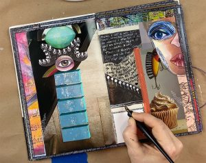 image of hand holding pen and journaling