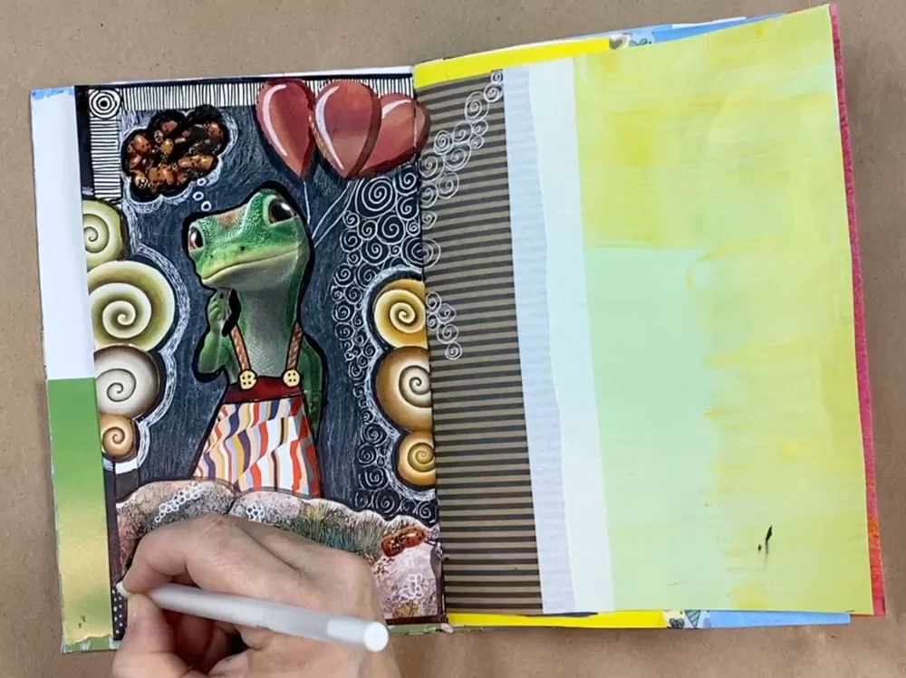 image of someone drawing in an art journal