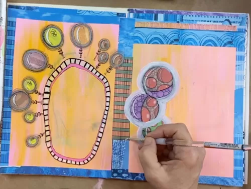 image of someone painting in an art journal